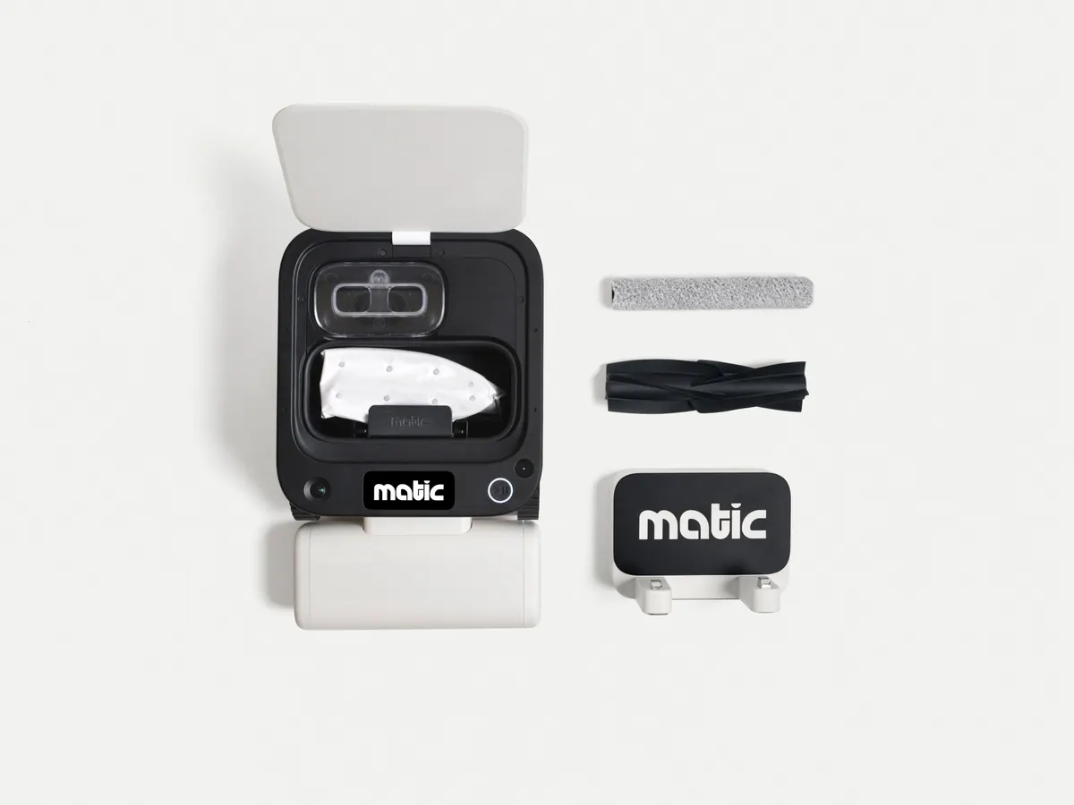 The Matic opened to show the HEPA bag beside its mop roller, rubber brush, and cover panel