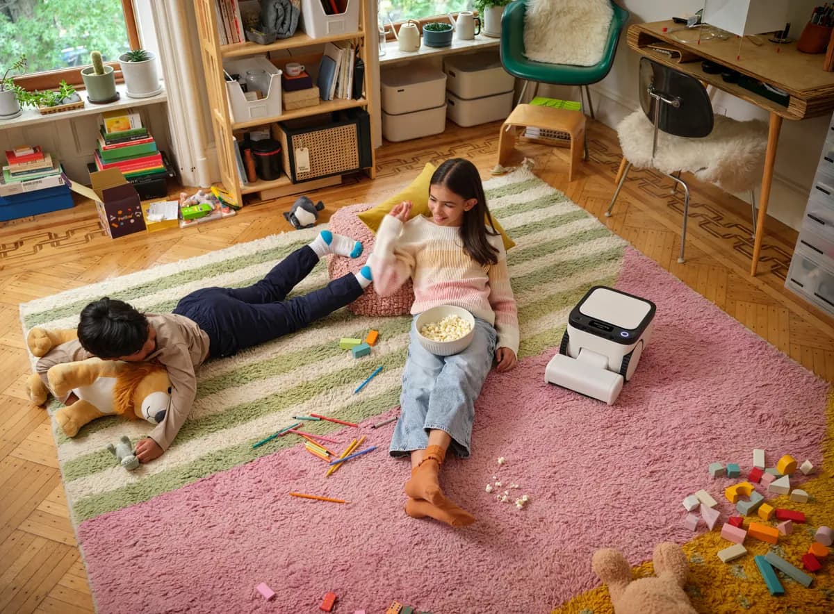 The Matic robot driving across the floor of a child's bedroom